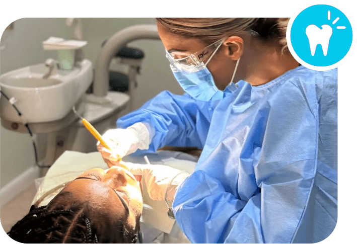 A dentist is working on the teeth of a patient.